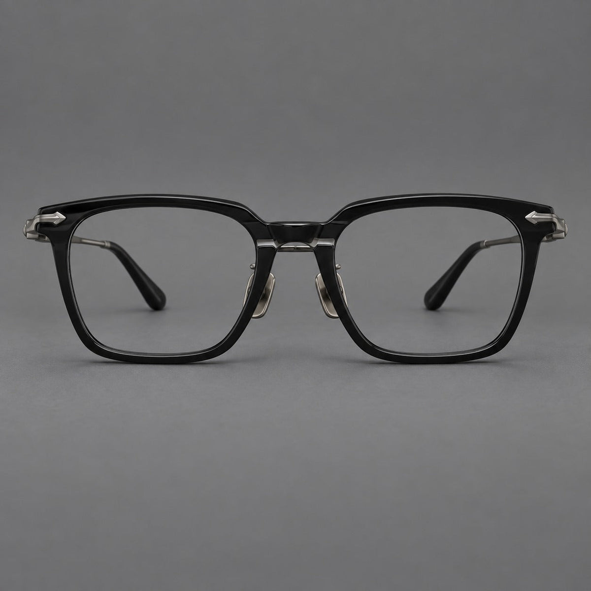 Bold acetate and titanium eyeglasses with rectangular rims and sculpted arrow accents in Black / Gunmetal, front view