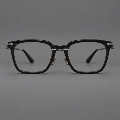 Bold acetate and titanium eyeglasses with rectangular rims and sculpted arrow accents in Black / Gunmetal, front view temple detail