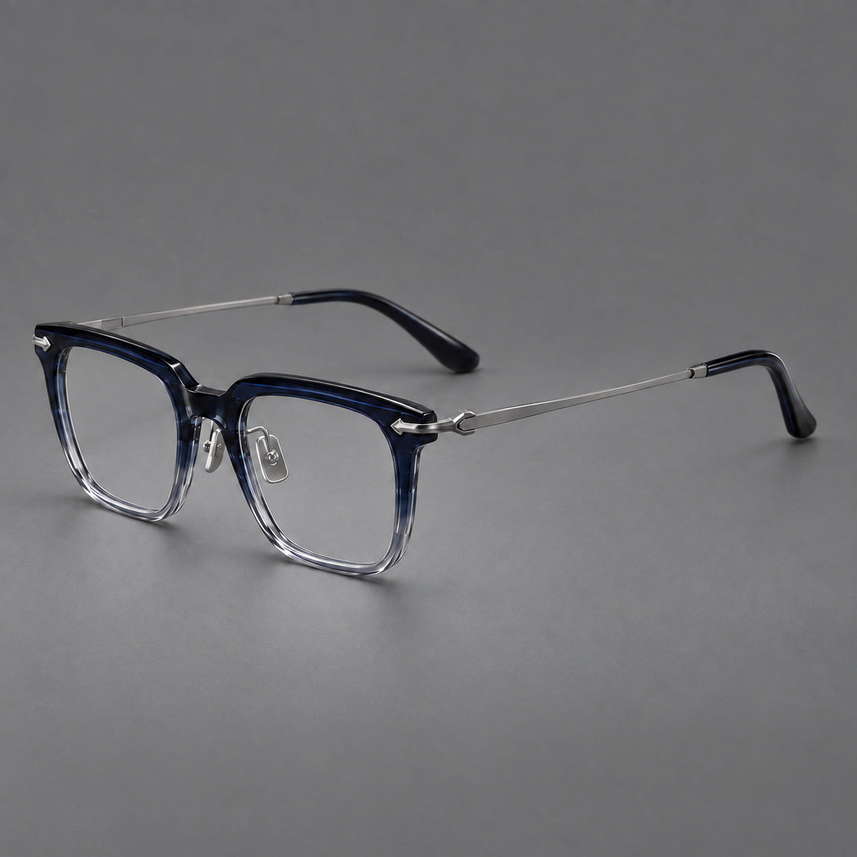 Bold acetate and titanium eyeglasses with rectangular rims and sculpted arrow accents in Blue Gradient / Silver Gray, three quarter view