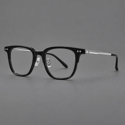Classic acetate and titanium eyeglasses with squared brows and paired corner rivets in Black / Silver, three quarter view front view