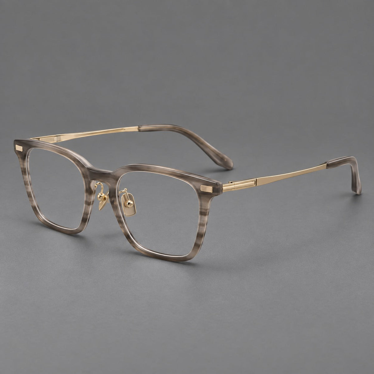 Classic acetate and titanium eyeglasses with rounded square rims and textured corner accents in Gray Woodgrain / Light Gold, three quarter view