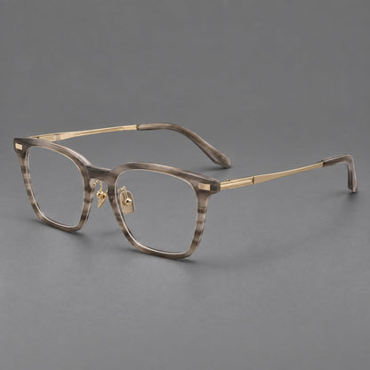 Classic acetate and titanium eyeglasses with rounded square rims and textured corner accents in Gray Woodgrain / Light Gold, three quarter view