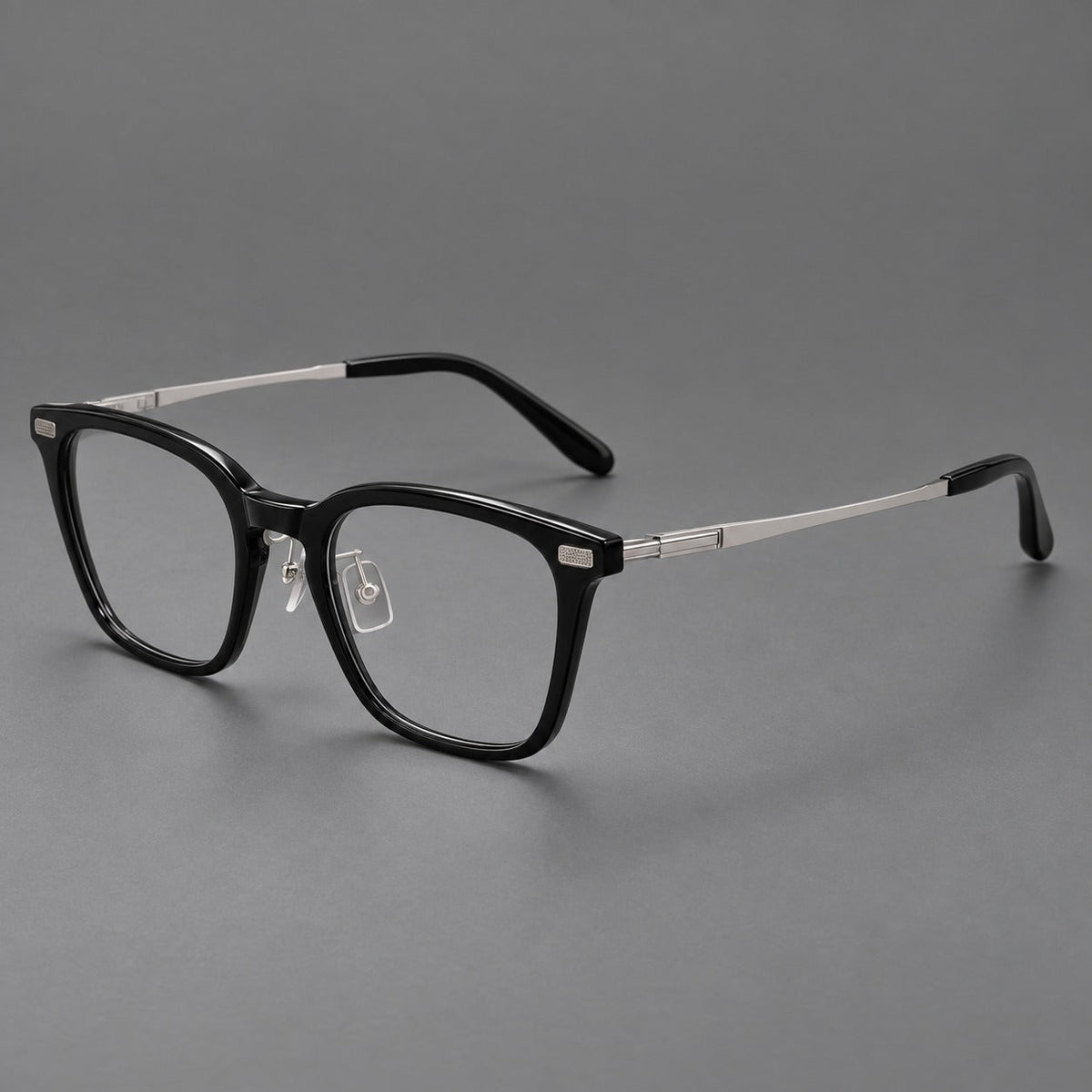 Classic acetate and titanium eyeglasses with rounded square rims and textured corner accents in Black / Silver, three quarter view