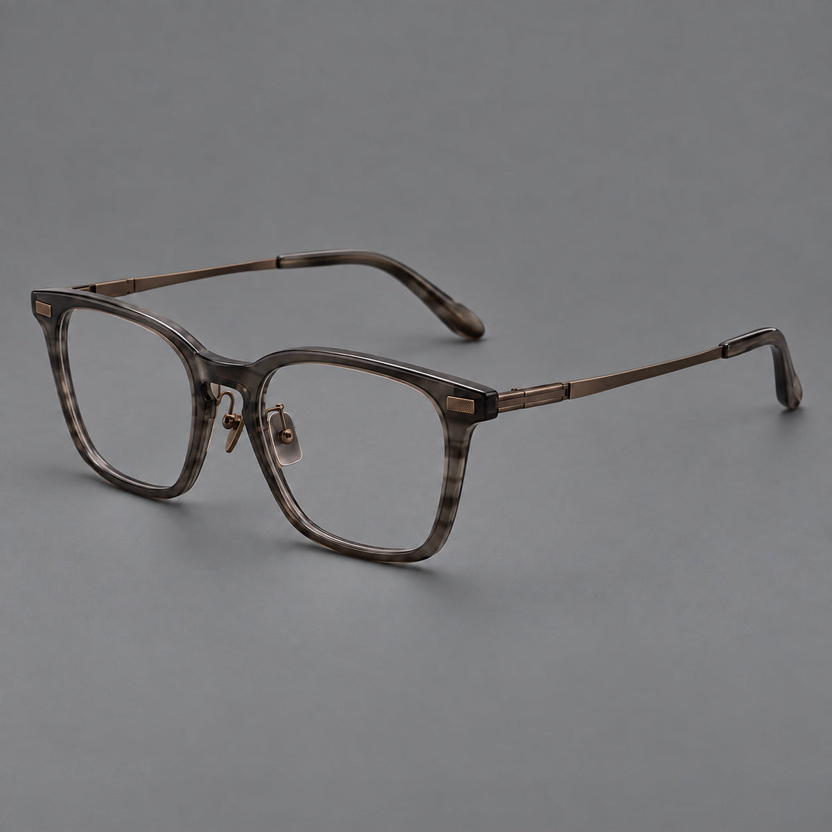 Classic acetate and titanium eyeglasses with rounded square rims and textured corner accents in Dark Gray / Antique Bronze, three quarter view