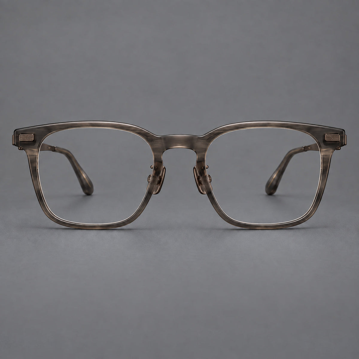 Classic acetate and titanium eyeglasses with rounded square rims and textured corner accents in Dark Gray / Antique Bronze, front view