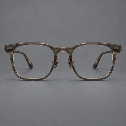 Classic acetate and titanium eyeglasses with rounded square rims and textured corner accents in Dark Gray / Antique Bronze, front view additional product view