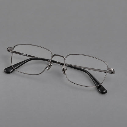 Modern square titanium glasses with an angular bridge and broad straight temples in Gunmetal, three quarter view front view