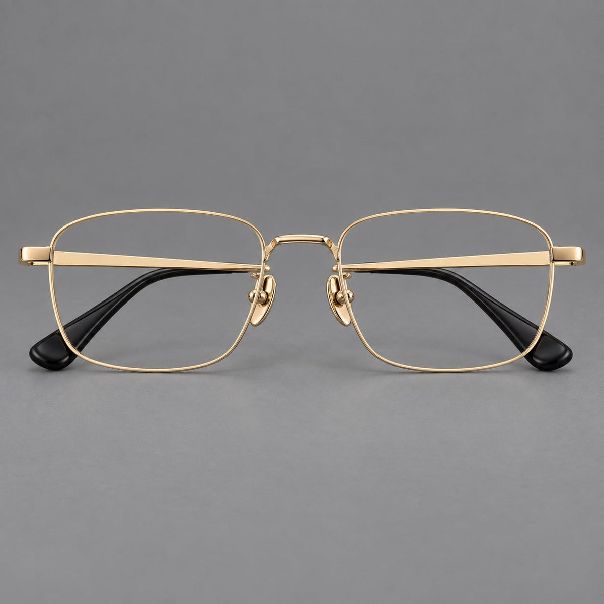 Modern square titanium glasses with an angular bridge and broad straight temples in Gold, front view