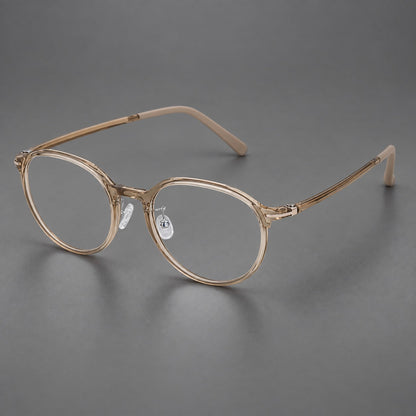 Retro round plastic eyeglasses with a curved bridge and slim metal corner accents in Tea, three quarter view lens detail