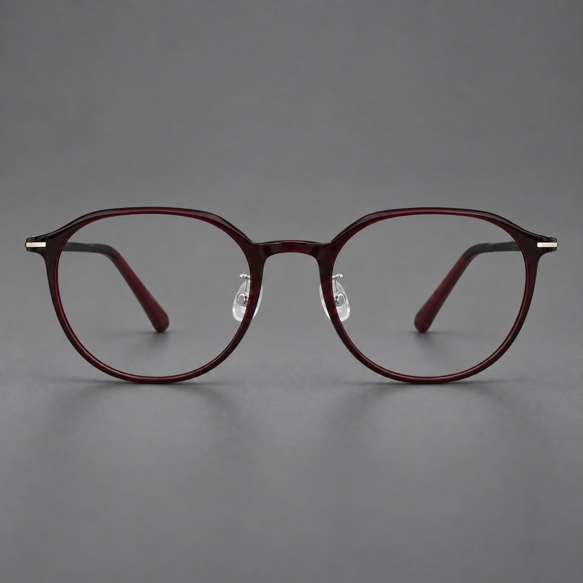 Retro round plastic eyeglasses with a curved bridge and slim metal corner accents in Deep Wine Red, front view