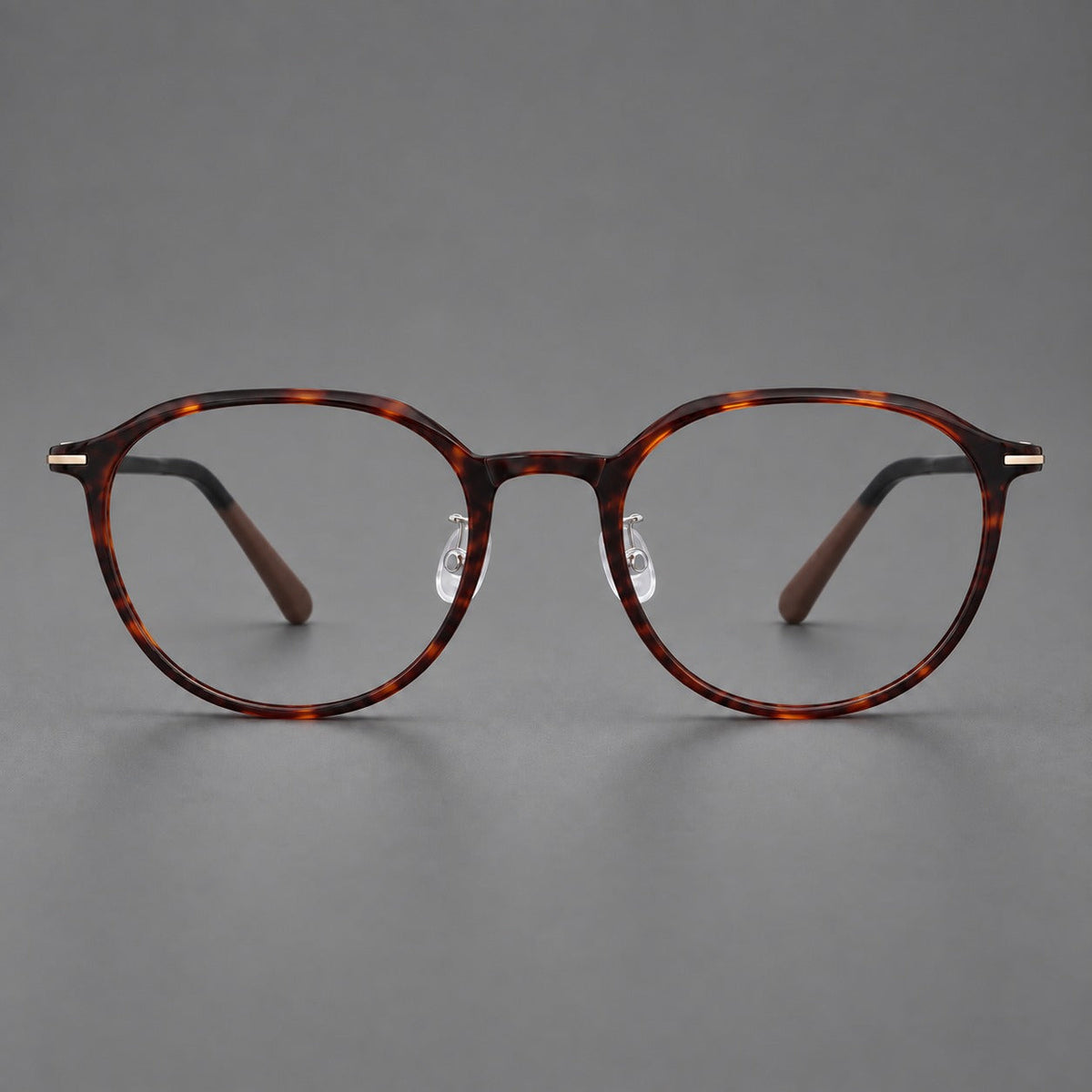 Retro round plastic eyeglasses with a curved bridge and slim metal corner accents in Tortoiseshell, front view