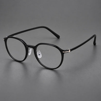 Compact round plastic eyeglasses with gently lifted corners and clear nose pads in Glossy Black, three quarter view