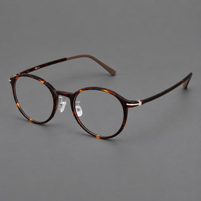 Compact round plastic eyeglasses with gently lifted corners and clear nose pads in Tortoiseshell, three quarter view additional product view