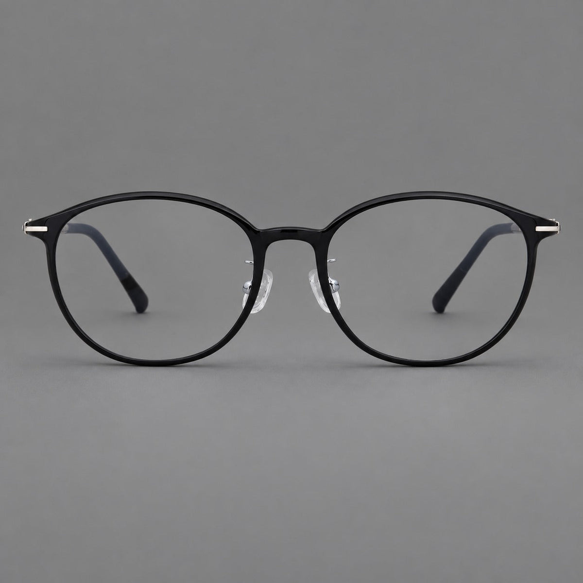 Slim oval plastic eyeglasses with a low profile and subtle metal corner accents in Glossy Black, front view