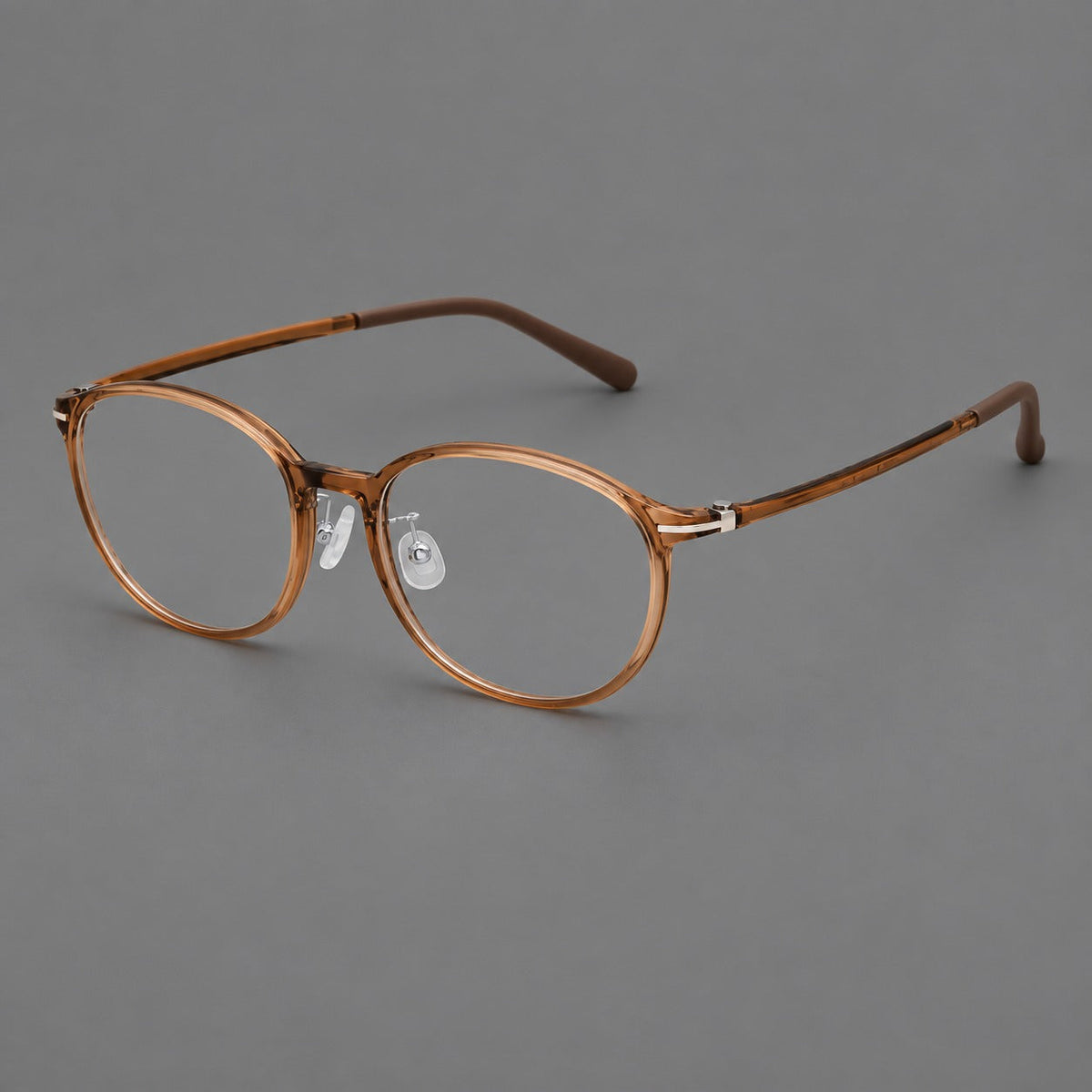 Slim oval plastic eyeglasses with a low profile and subtle metal corner accents in Honey Tea, three quarter view