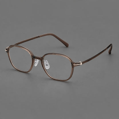 Rounded geometric plastic eyeglasses with softly angled rims and a curved bridge in Ink Brown, three quarter view lens detail