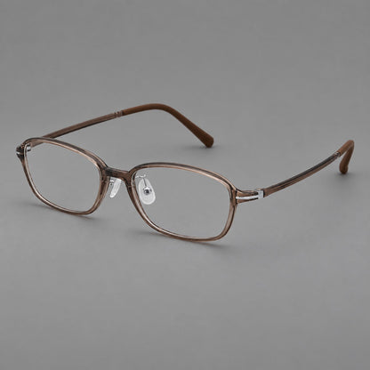 Soft oval plastic eyeglasses with a narrow bridge and gently rounded outer corners in Ink Brown, three quarter view lens detail