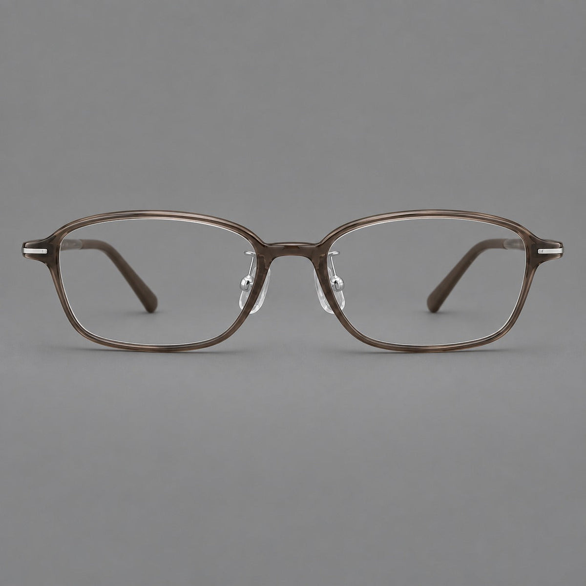 Soft oval plastic eyeglasses with a narrow bridge and gently rounded outer corners in Ink Brown, front view