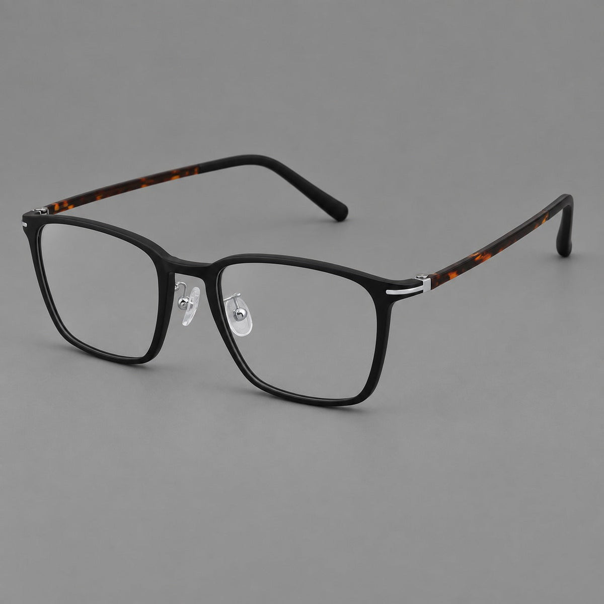 Modern square plastic eyeglasses with a smooth browline and slim metal corner details in Matte Black, three quarter view