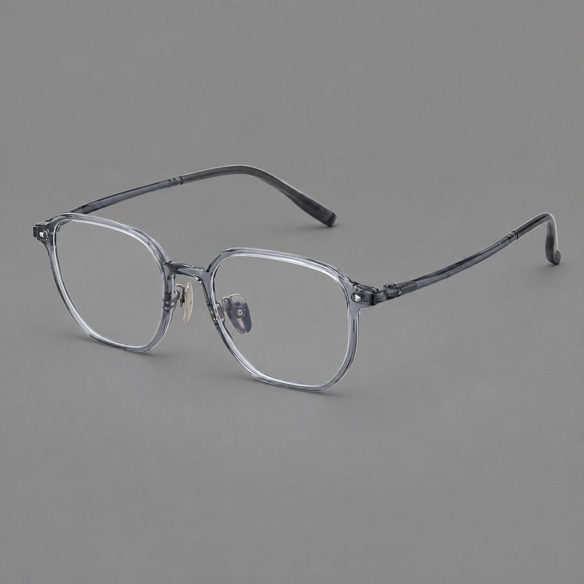 Soft square plastic eyeglasses with rounded lower rims and a broad curved bridge in Ink Gray, three quarter view