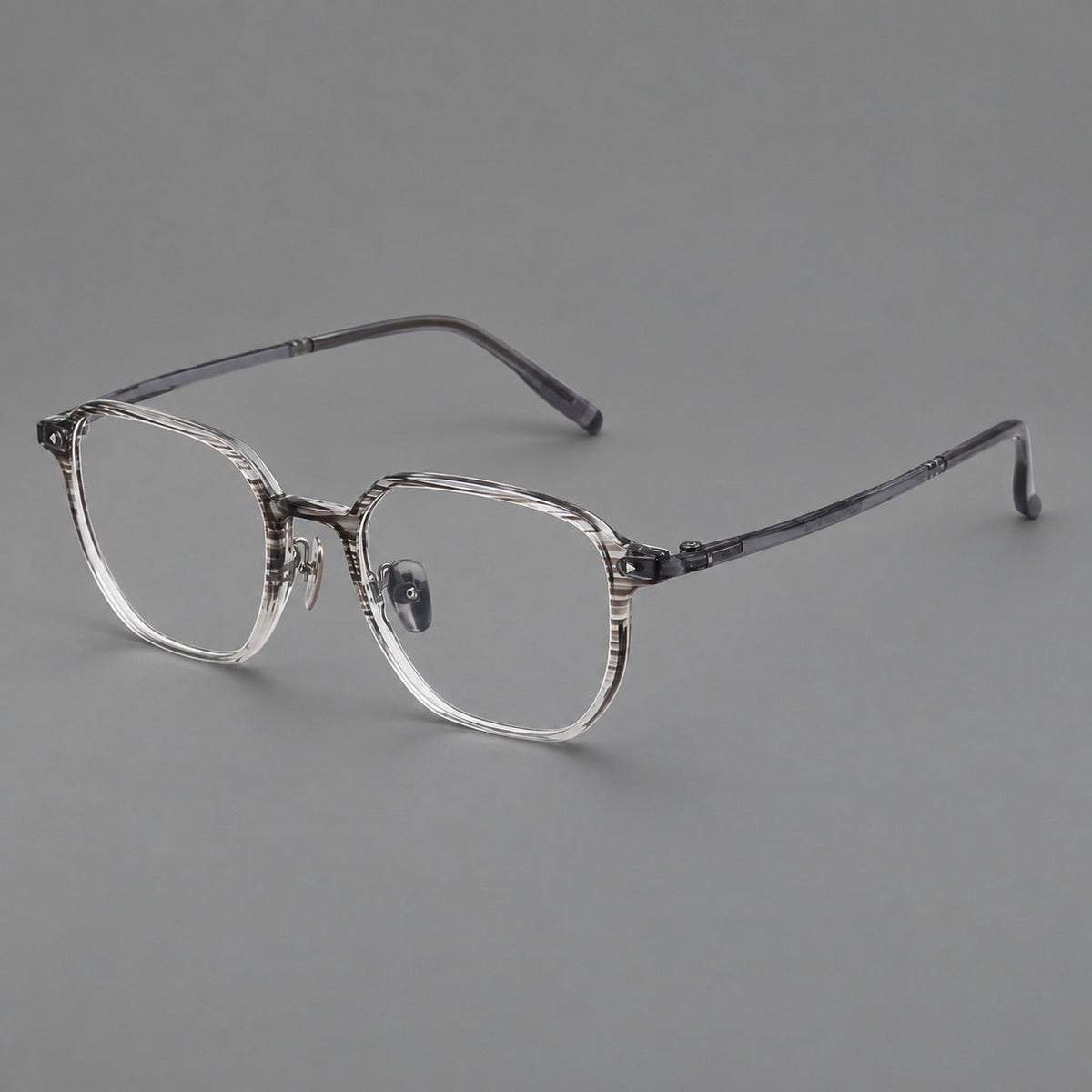 Soft square plastic eyeglasses with rounded lower rims and a broad curved bridge in Striped Gray Gradient, three quarter view