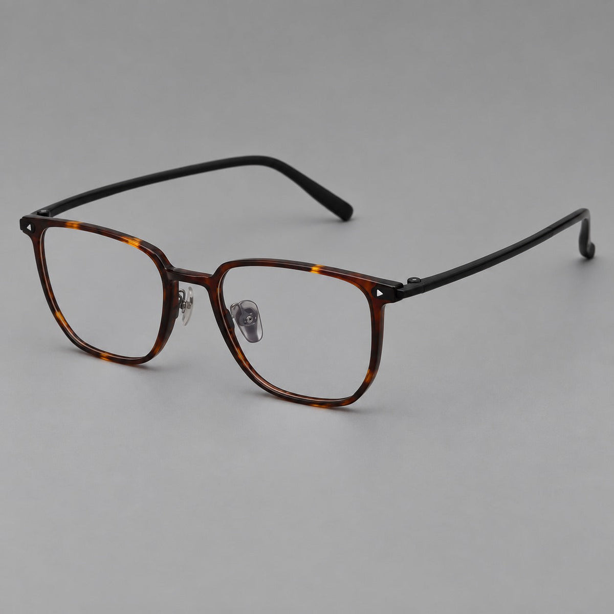 Refined rectangular plastic eyeglasses with raised outer corners and clear nose pads in Tortoiseshell, three quarter view