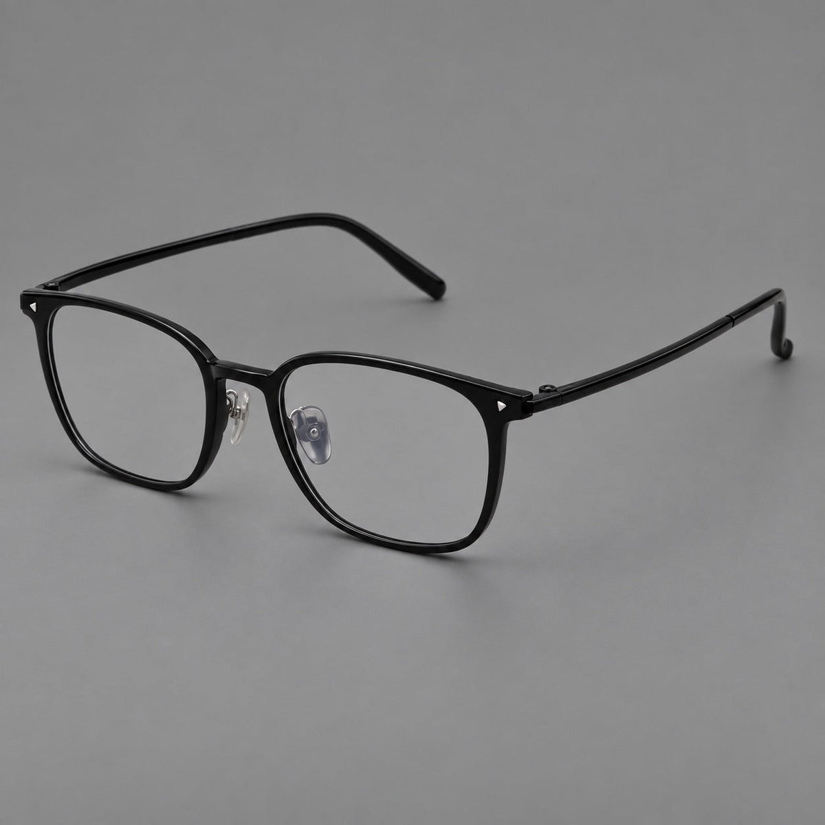 Classic soft square plastic eyeglasses with a gently curved browline and corner studs in Glossy Black, three quarter view