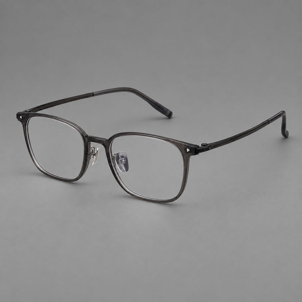Classic soft square plastic eyeglasses with a gently curved browline and corner studs in Dark Gray, three quarter view