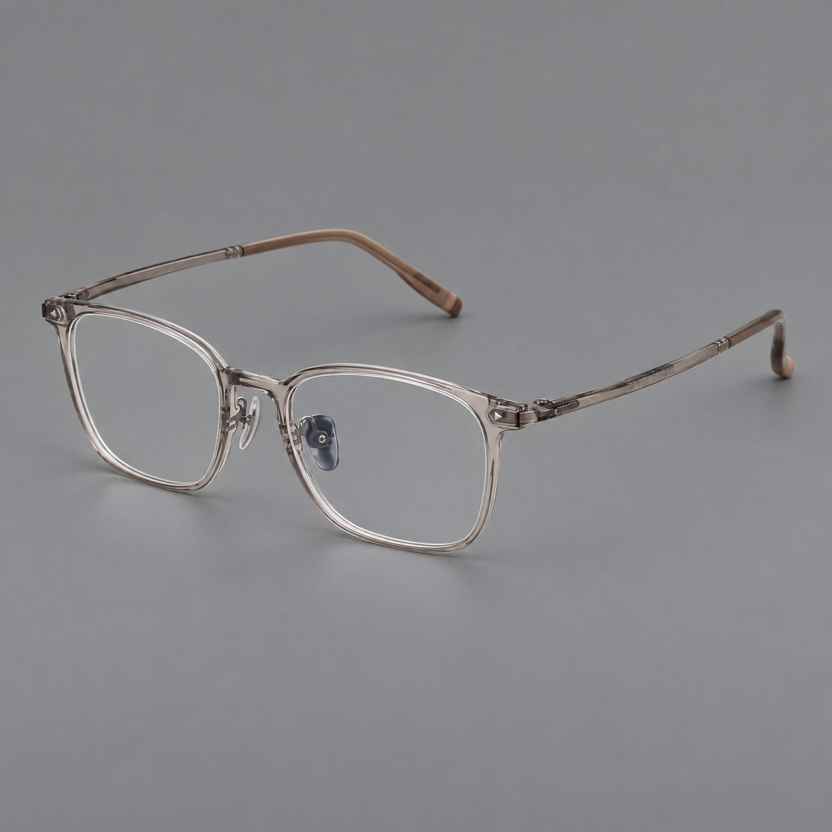 Classic soft square plastic eyeglasses with a gently curved browline and corner studs in Gray Tea, three quarter view