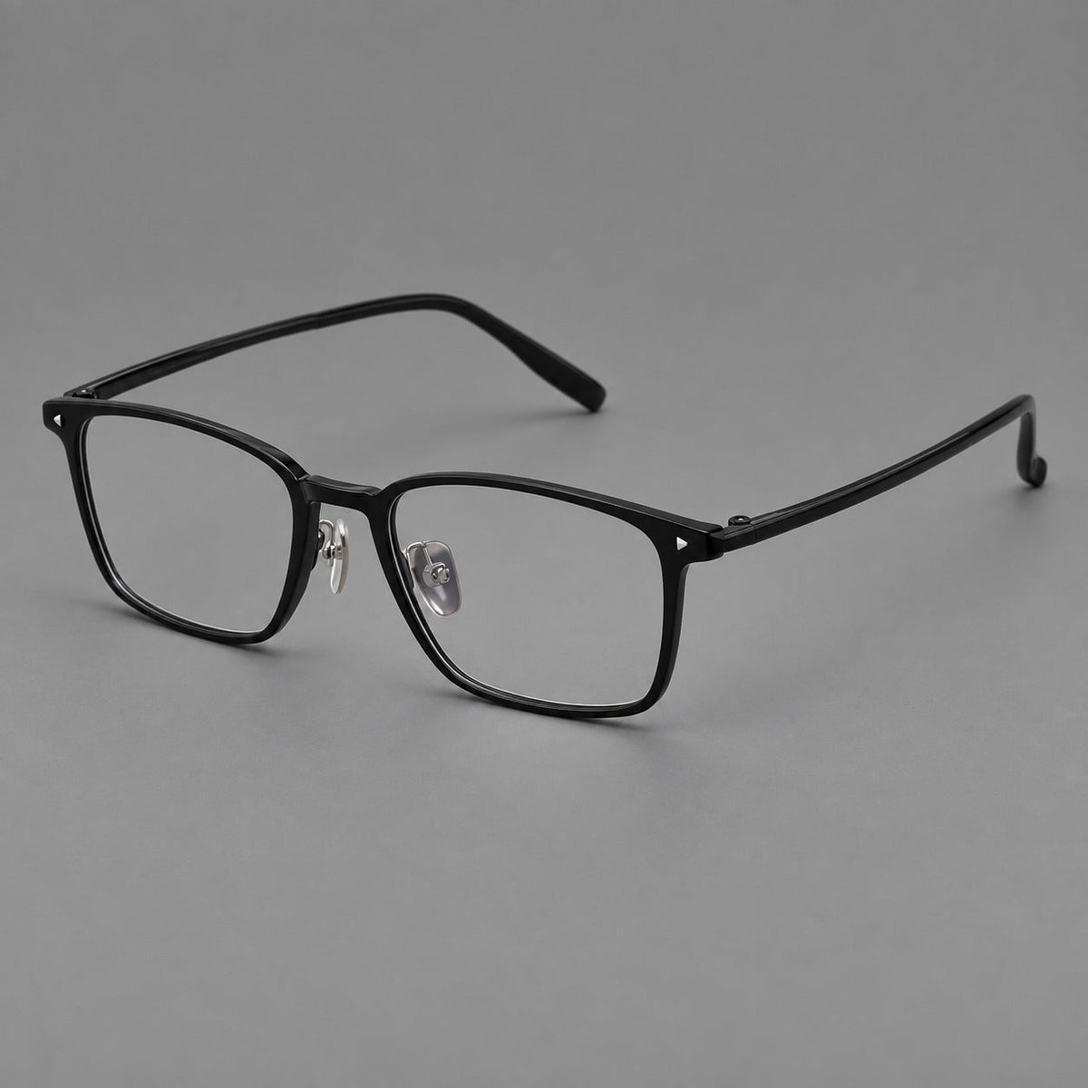 Clean rectangular plastic eyeglasses with flat lower rims and pointed corner details in Glossy Black, three quarter view