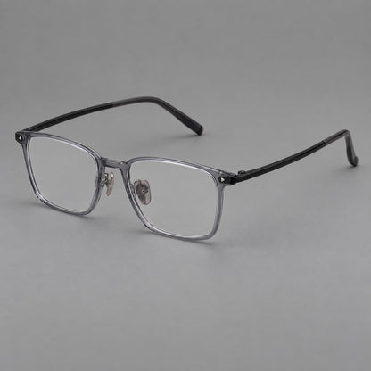Clean rectangular plastic eyeglasses with flat lower rims and pointed corner details in Ink Gray, three quarter view front view
