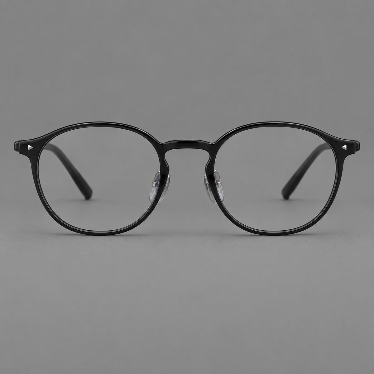Vintage round plastic eyeglasses with a curved bridge and subtle triangular accents in Glossy Black, front view