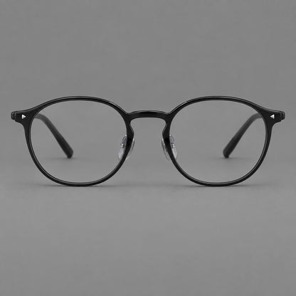 Vintage round plastic eyeglasses with a curved bridge and subtle triangular accents in Glossy Black, front view side view