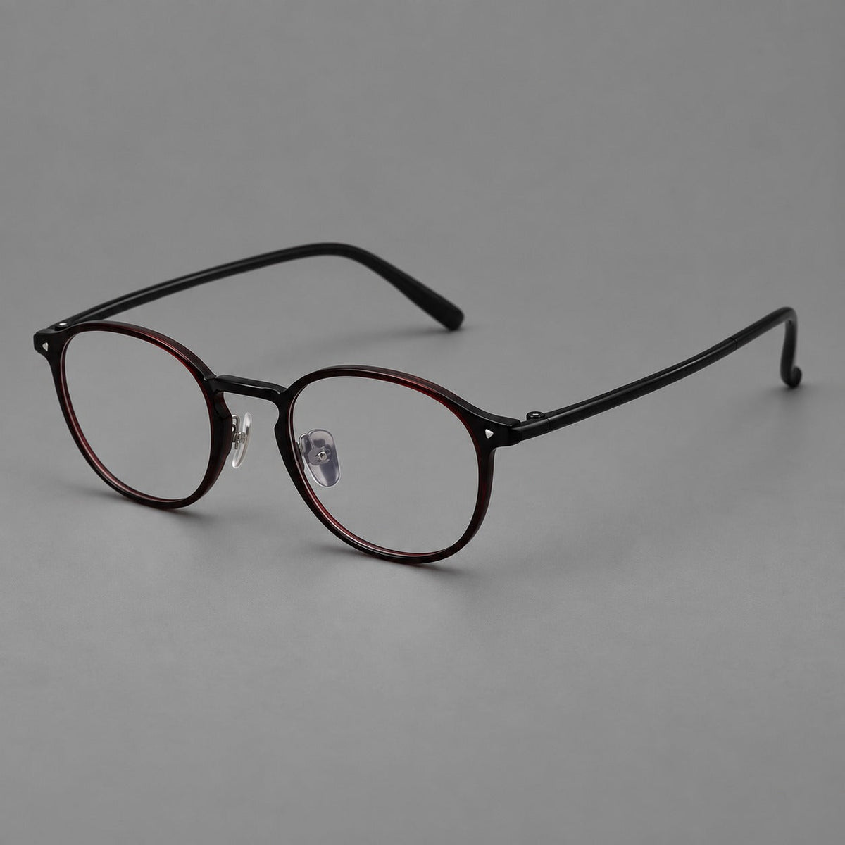 Vintage round plastic eyeglasses with a curved bridge and subtle triangular accents in Deep Wine Red, three quarter view