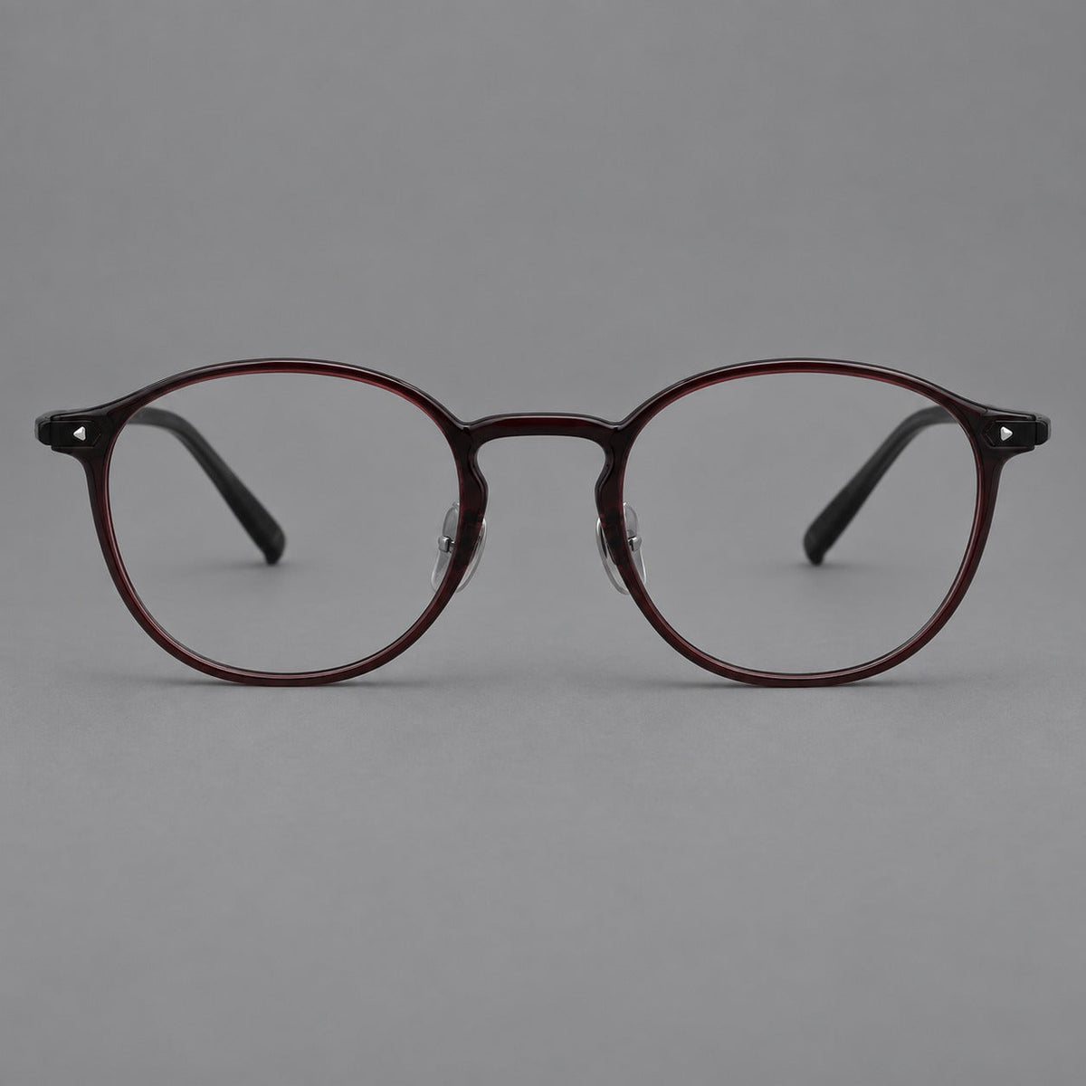 Vintage round plastic eyeglasses with a curved bridge and subtle triangular accents in Deep Wine Red, front view