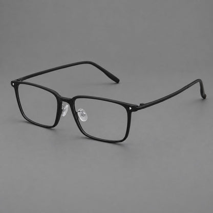 Wide rectangular plastic eyeglasses with an angular browline and slender rims in Matte Black, three quarter view lens detail