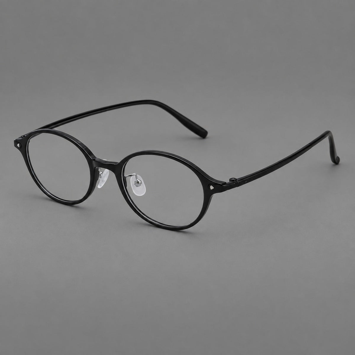 Retro round plastic eyeglasses with softly lifted corners and a sculpted bridge in Glossy Black, three quarter view