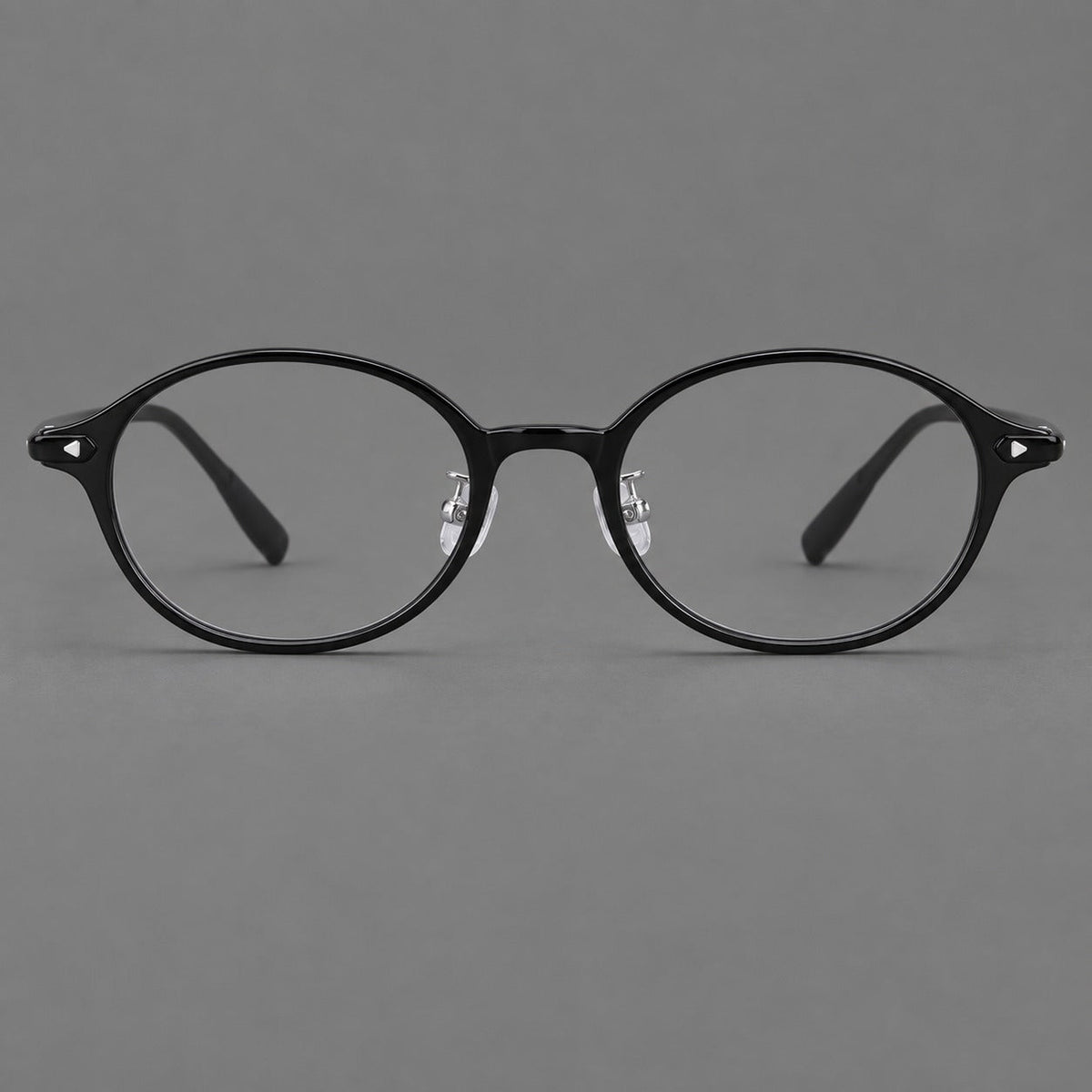 Retro round plastic eyeglasses with softly lifted corners and a sculpted bridge in Glossy Black, front view