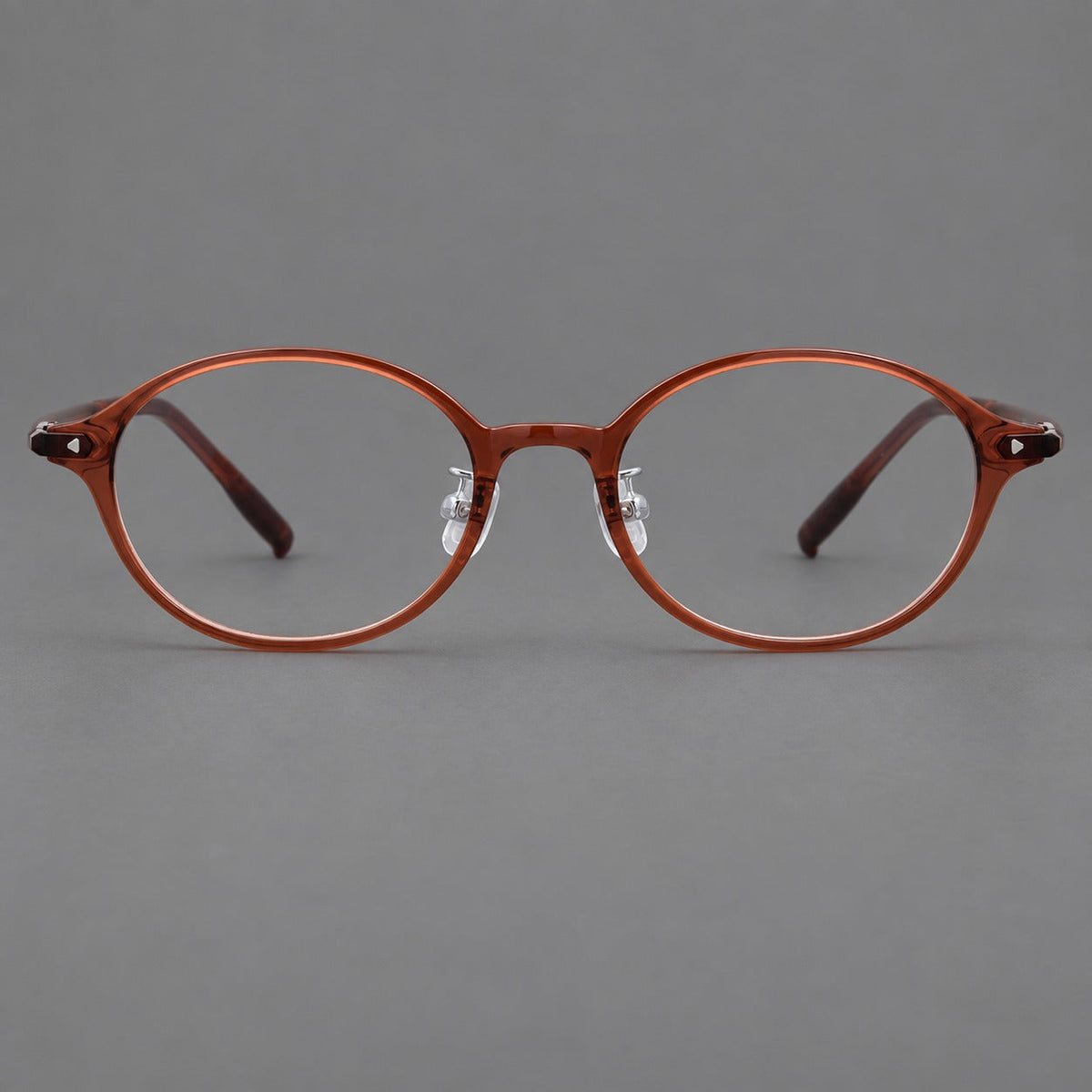 Retro round plastic eyeglasses with softly lifted corners and a sculpted bridge in Brown Red, front view