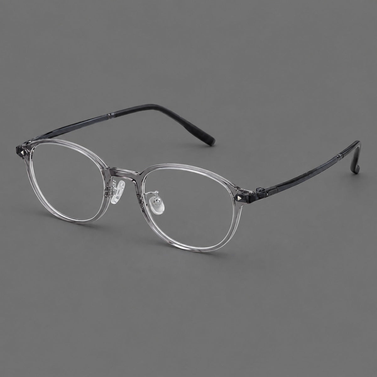 Panto plastic eyeglasses with a rounded silhouette and triangular corner studs in Gray, three quarter view