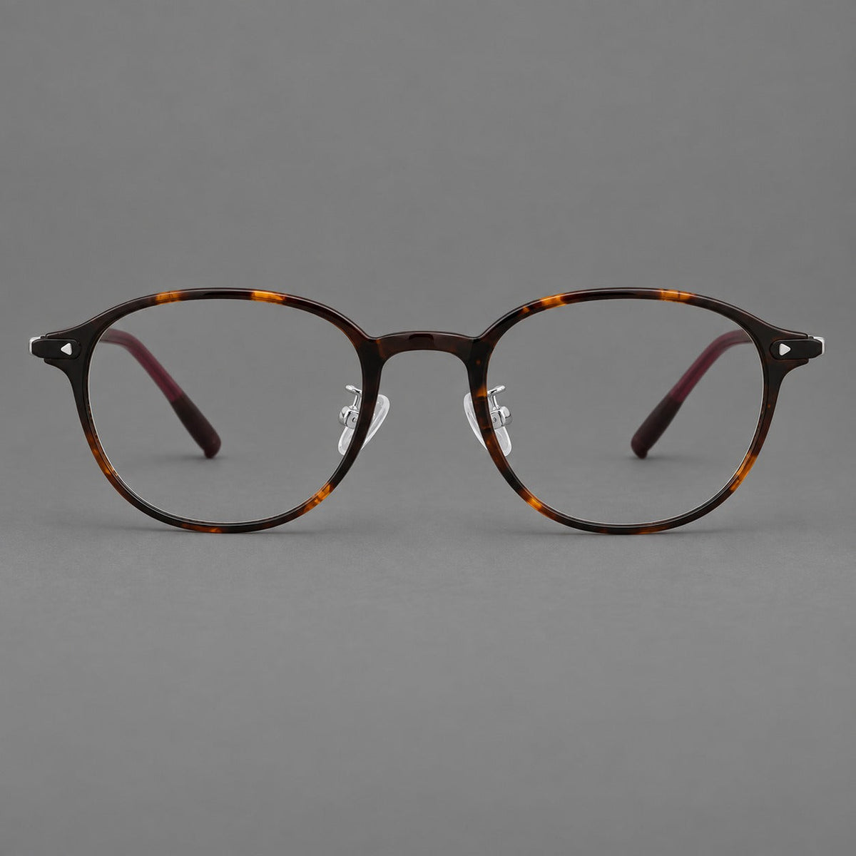 Panto plastic eyeglasses with a rounded silhouette and triangular corner studs in Tortoiseshell, front view