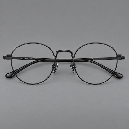 Retro round titanium glasses with a raised bridge and smooth corner shoulders in Black, front view side view