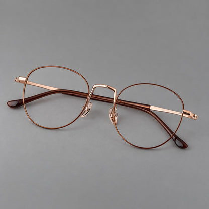 Retro round titanium glasses with a raised bridge and smooth corner shoulders in Brown and Rose Gold, three quarter view front view