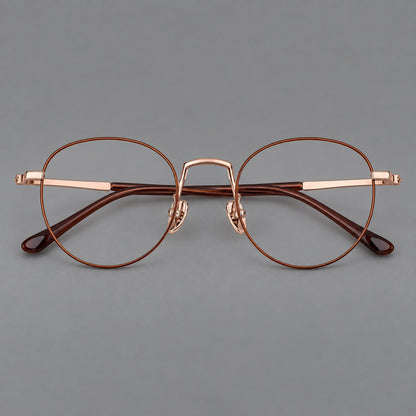 Retro round titanium glasses with a raised bridge and smooth corner shoulders in Brown and Rose Gold, front view frame detail