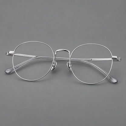 Retro round titanium glasses with a raised bridge and smooth corner shoulders in Silver, three quarter view additional product view