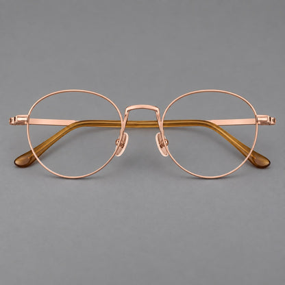Retro round titanium glasses with a raised bridge and smooth corner shoulders in Rose Gold, front view additional product view
