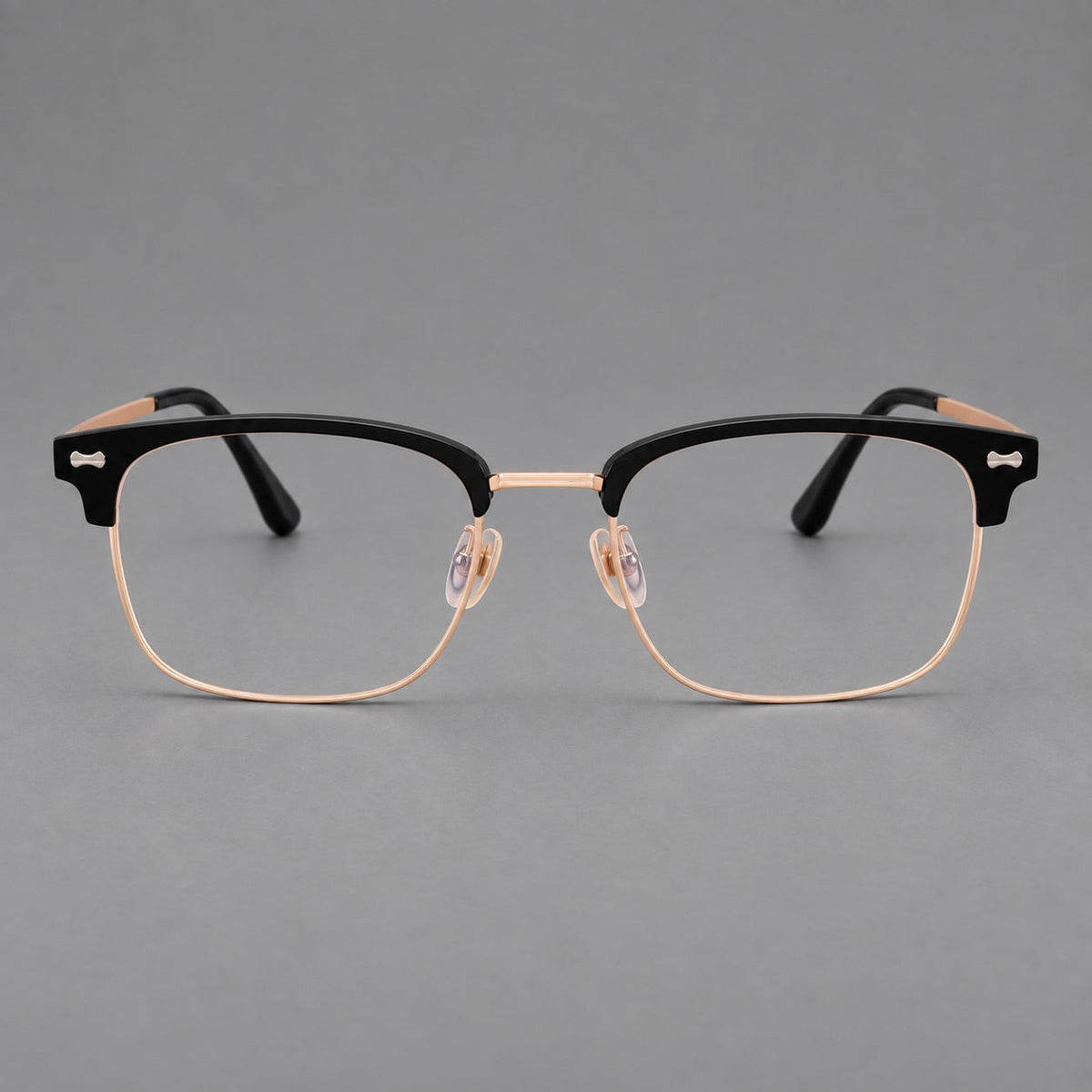 Classic browline titanium glasses with fine lower rims and subtle corner accents in Black and Rose Gold, front view