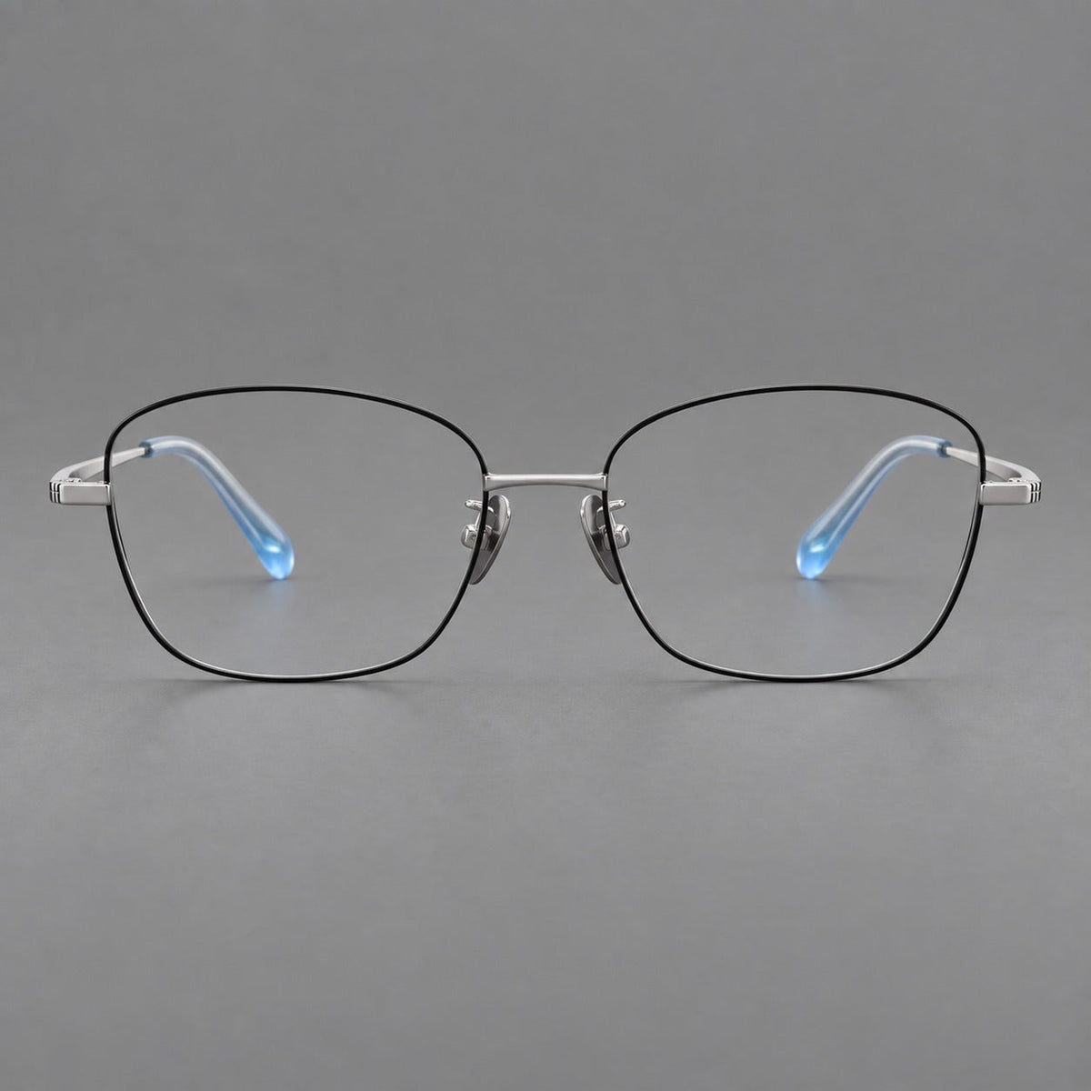 Soft square titanium glasses with angled upper corners and decorated hinges in Black and Silver, front view