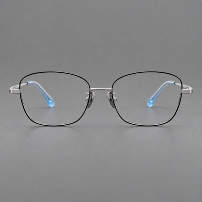 Soft square titanium glasses with angled upper corners and decorated hinges in Black and Silver, front view frame detail