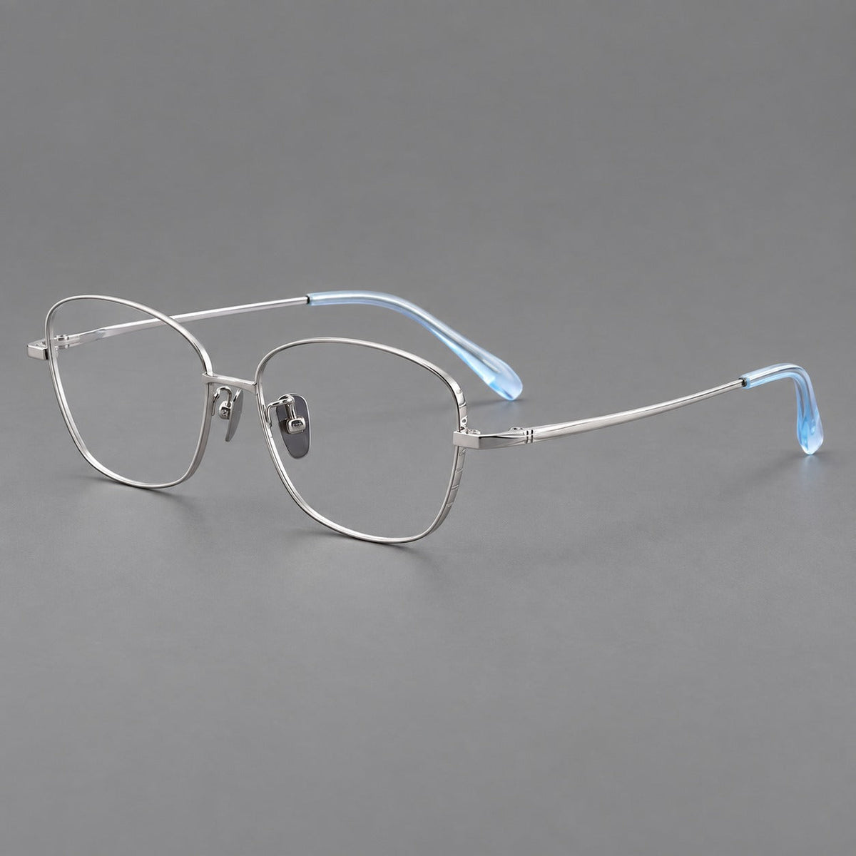 Soft square titanium glasses with angled upper corners and decorated hinges in Silver, three quarter view